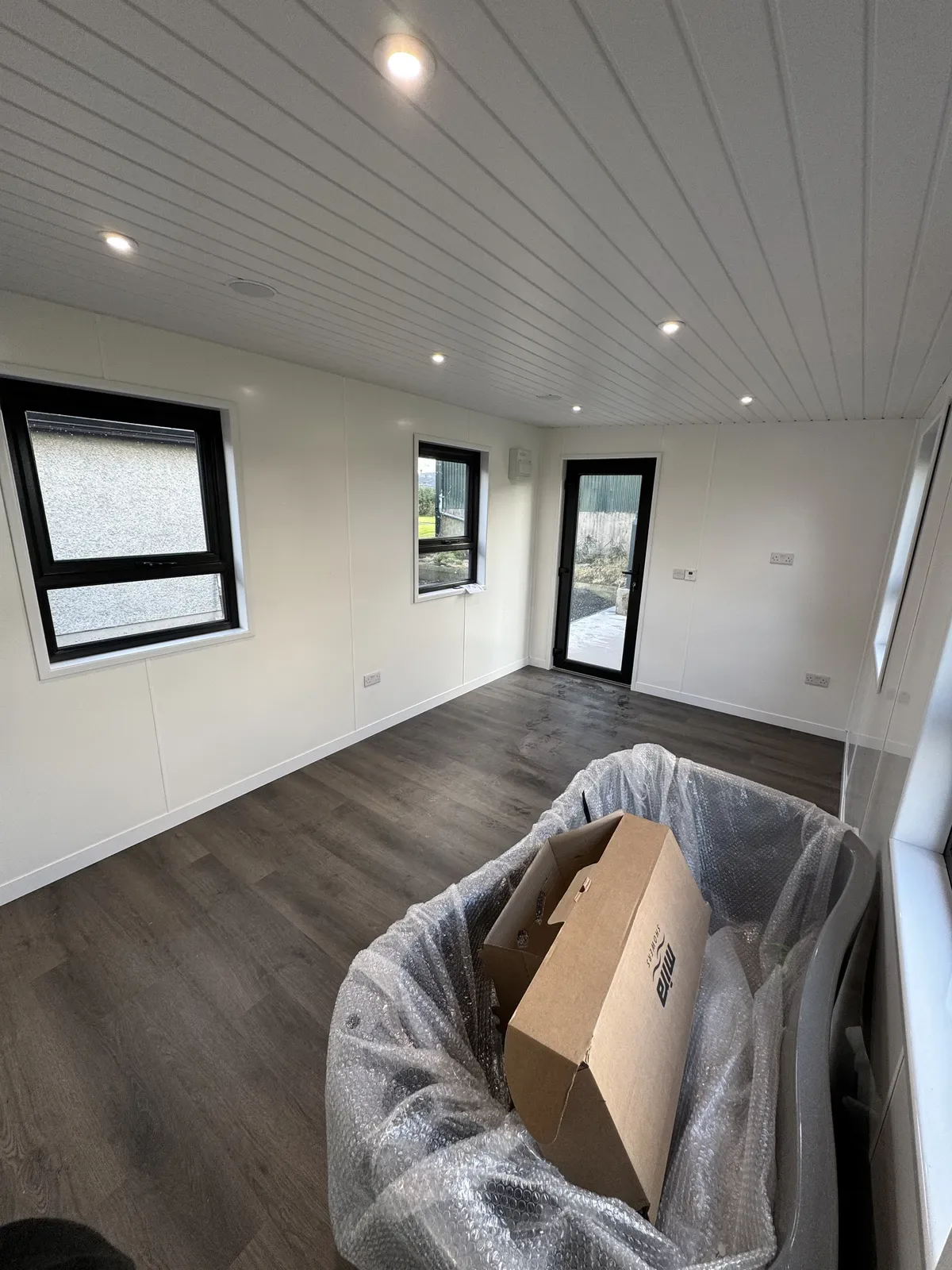 Garden room interior with windows on three sides
